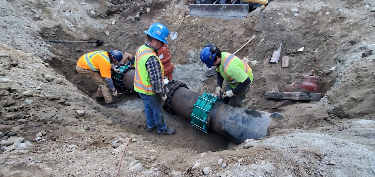 Utility crews install water pipes