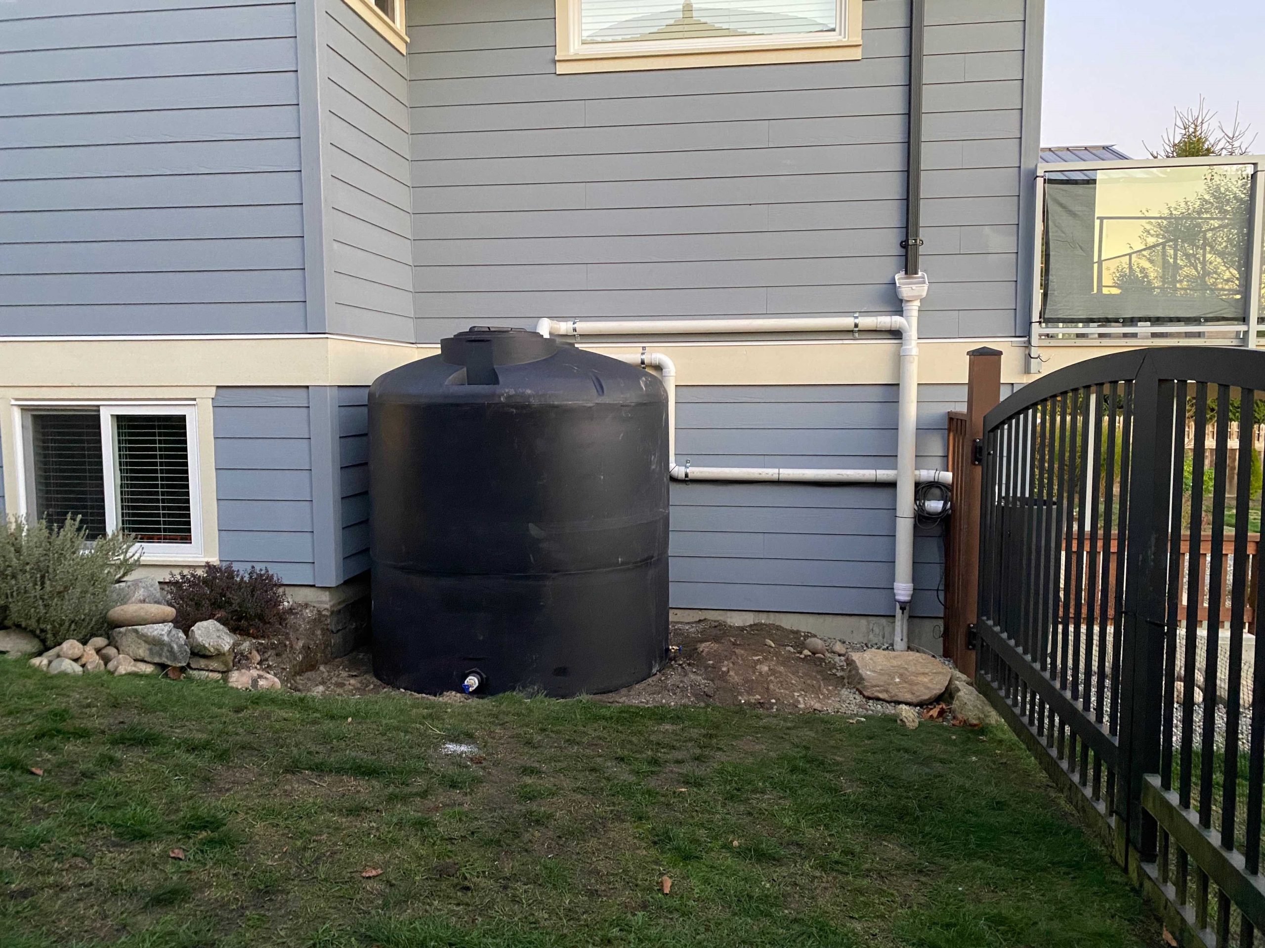 Picture shows a rainwater harvesting system beside a home