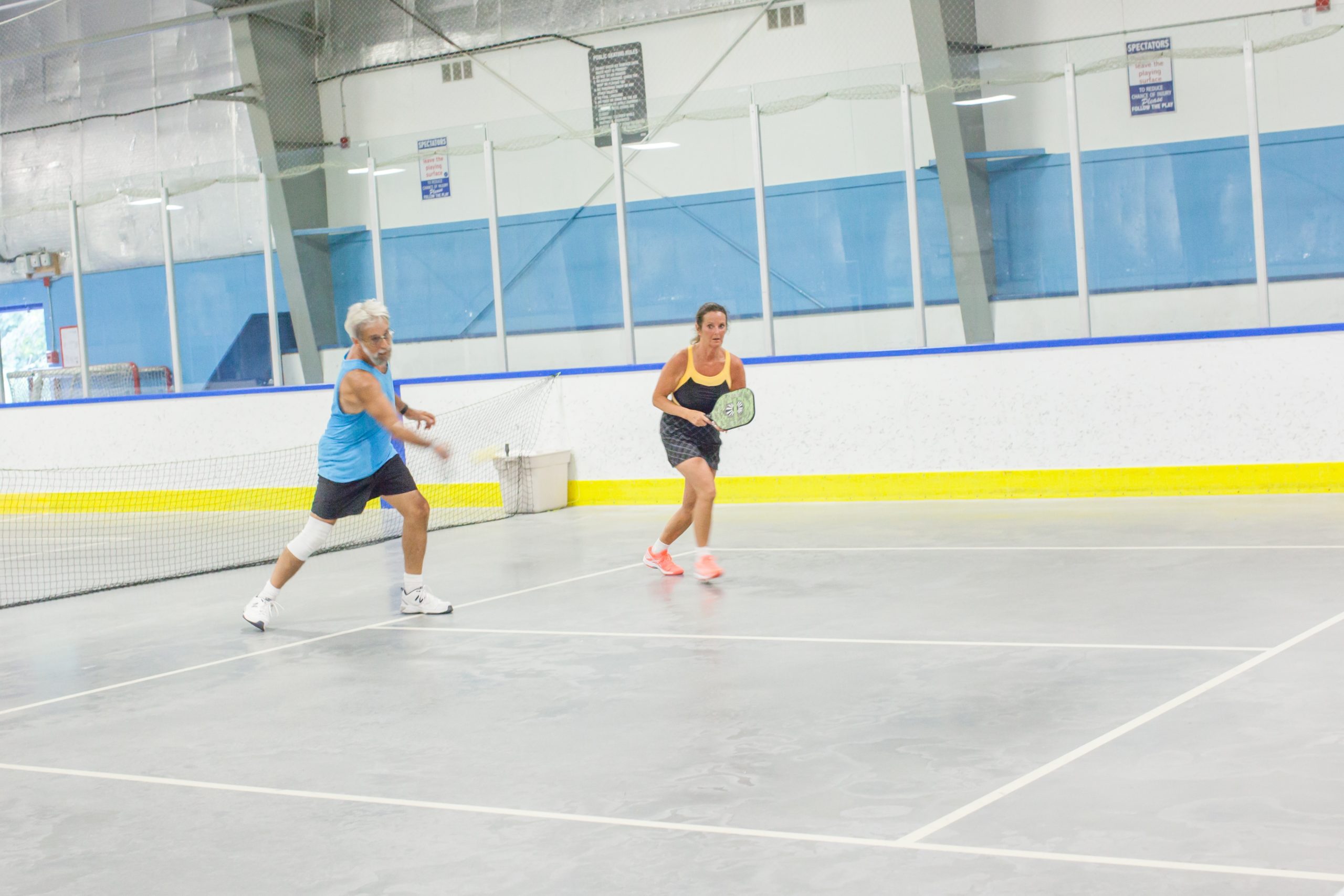 two people playing pickleball