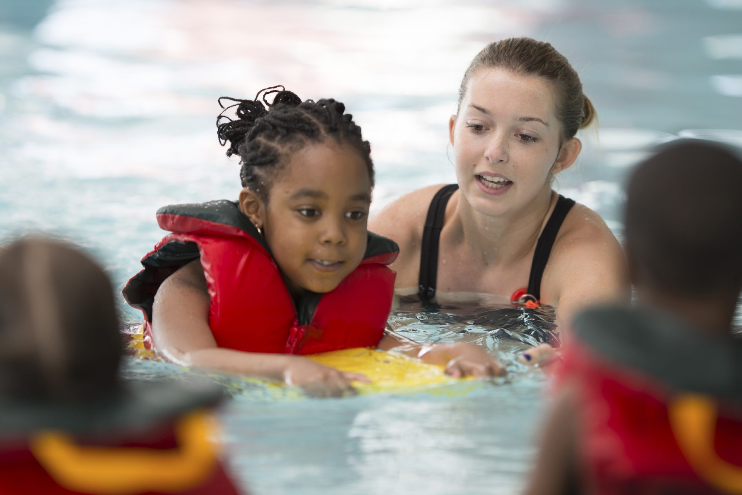 children taking part in a swimming lesson